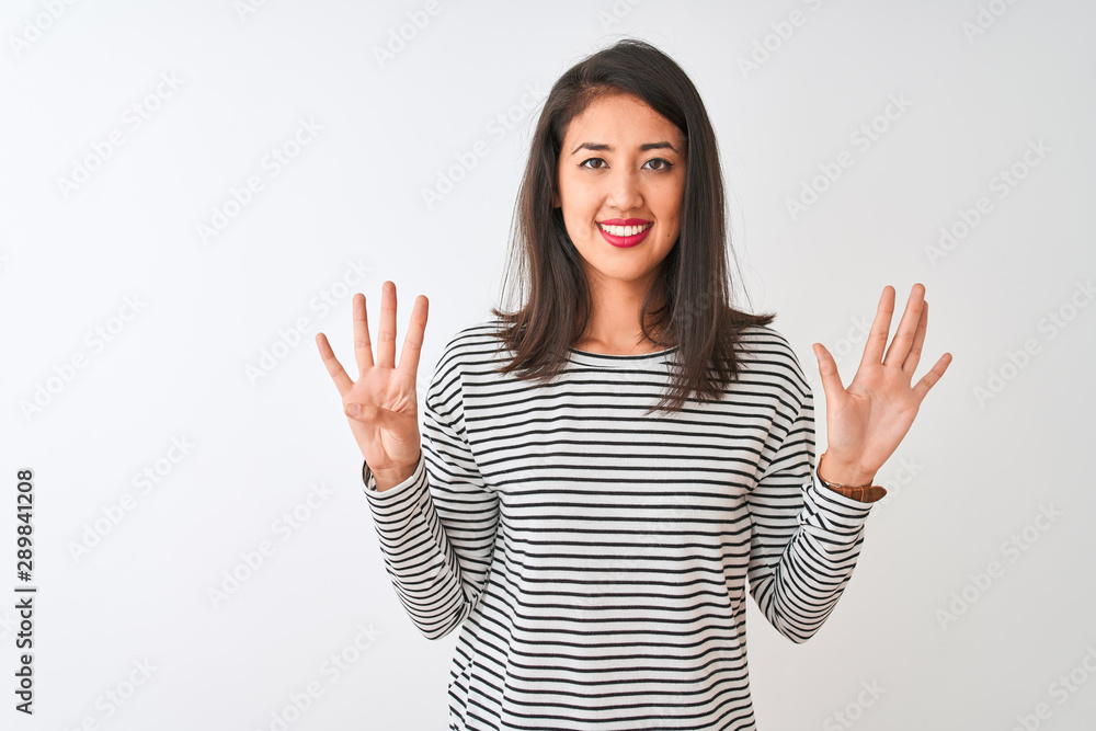 Young beautiful chinese woman wearing striped t-shirt standing over isolated white background showing and pointing up with fingers number nine while smiling confident and happy. Young beautiful chinese woman wearing striped t-shirt standing over isolated white background showing and pointing up with fingers number nine while smiling confident and happy.