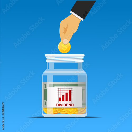 hand putting coin in dividend jar,investment concept.