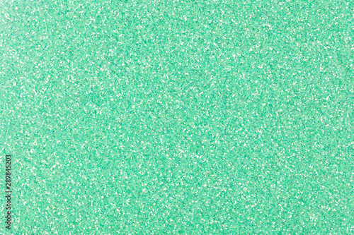 New green holographic glitter background for your excellent Christmas design in light tone.