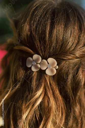 beautiful plastic hairpin delicate peach color with flowers for the bride on the girl s hair . wedding accessory.