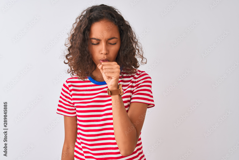 Young brazilian woman wearing red striped t-shirt standing over isolated white background feeling unwell and coughing as symptom for cold or bronchitis. Healthcare concept. Young brazilian woman wearing red striped t-shirt standing over isolated white background feeling unwell and coughing as symptom for cold or bronchitis. Healthcare concept.