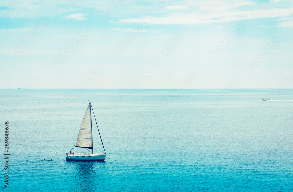 Sea view with sailboat, motor boat from Taormina, Sicily, Italy.