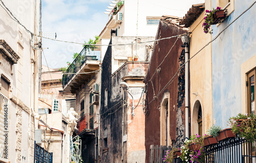 Travel to Italy -  historical street of Acitrezza, Catania, Sicily, facade of old buildings. © Inna