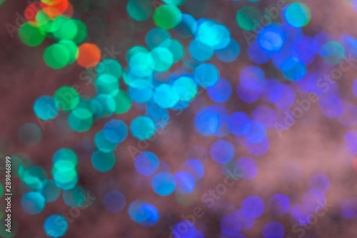 Colorful prism confetti blurred festive bokeh backdrop, trendy sparkles and glitter background, flat lay. Christmas and holidays concept, 2020 new year celebration