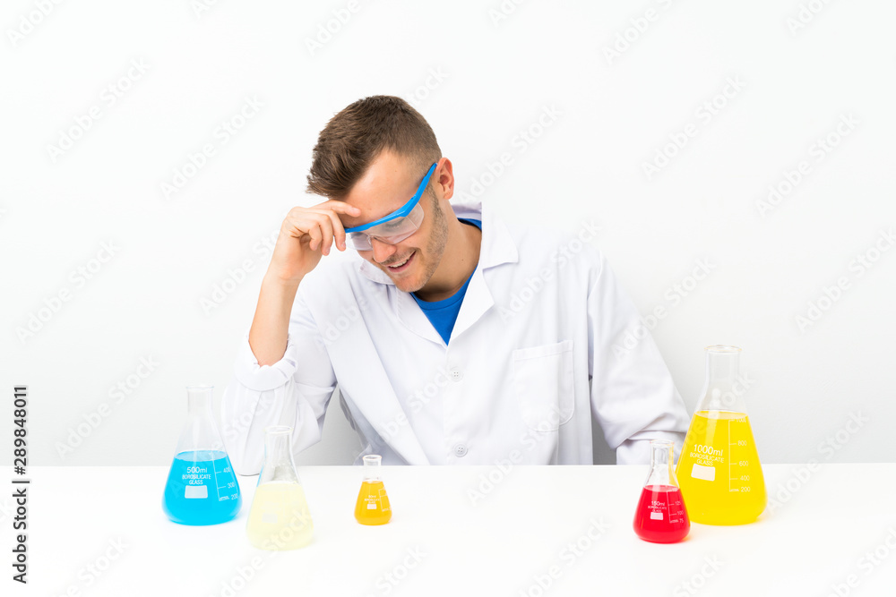 Young scientific with lots of laboratory flask laughing Young scientific with lots of laboratory flask laughing