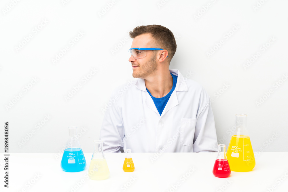 Young scientific with lots of laboratory flask laughing Young scientific with lots of laboratory flask laughing