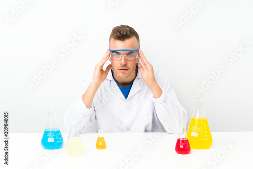 Young scientific with lots of laboratory flask unhappy and frustrated with something. Negative facial expression