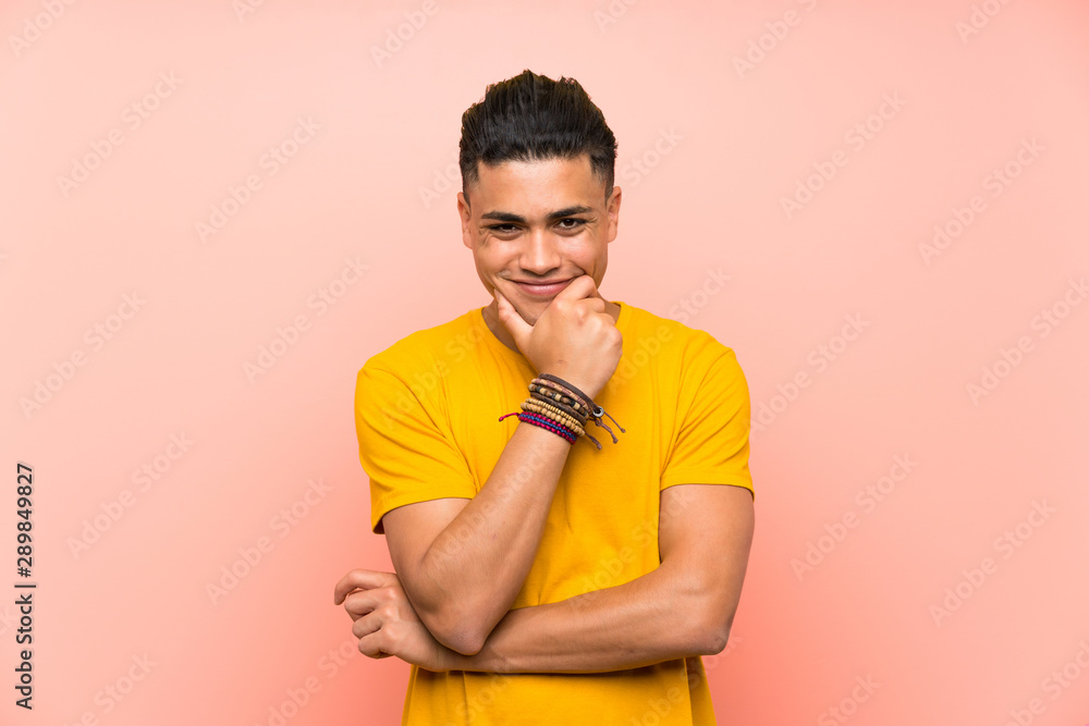 Young man with yellow shirt over isolated pink wall laughing Young man with yellow shirt over isolated pink wall laughing