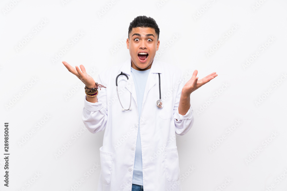 Young doctor man over isolated white wall with shocked facial expression Young doctor man over isolated white wall with shocked facial expression