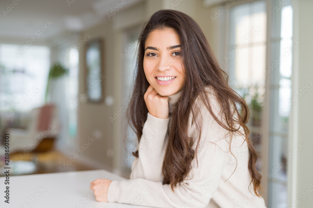 Beautiful brunette woman smiling cheerful with big smile, looking positive and happy with crossed arms Beautiful brunette woman smiling cheerful with big smile, looking positive and happy with crossed arms