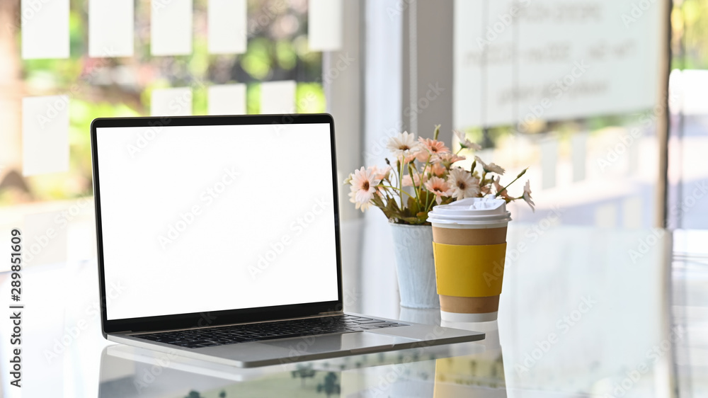 Laptop computer, take away coffee and flower on table. Laptop computer, take away coffee and flower on table.