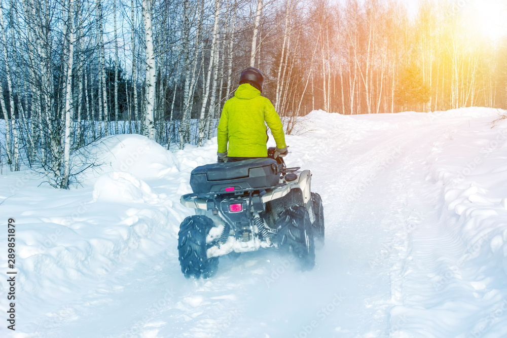 Rider driving in the quad bike race in winter. Rider driving in the quad bike race in winter.