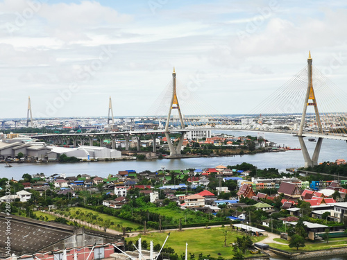 Bhumibol Bridge with river, cityscape view and cloudy blue sky in the morning.
