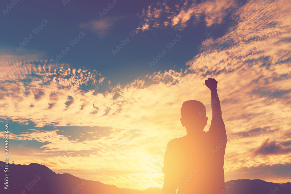 Copy space of man rise hand up on top of mountain and sunset sky abstract background. - obrazy, fototapety, plakaty 