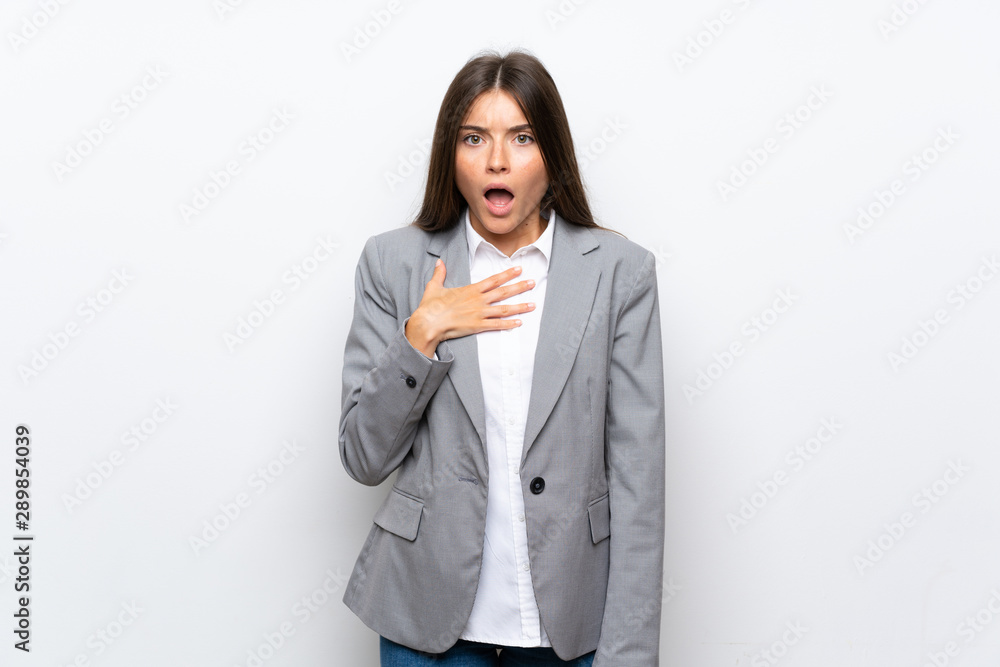 Young business woman over isolated white background surprised and shocked while looking right Young business woman over isolated white background surprised and shocked while looking right