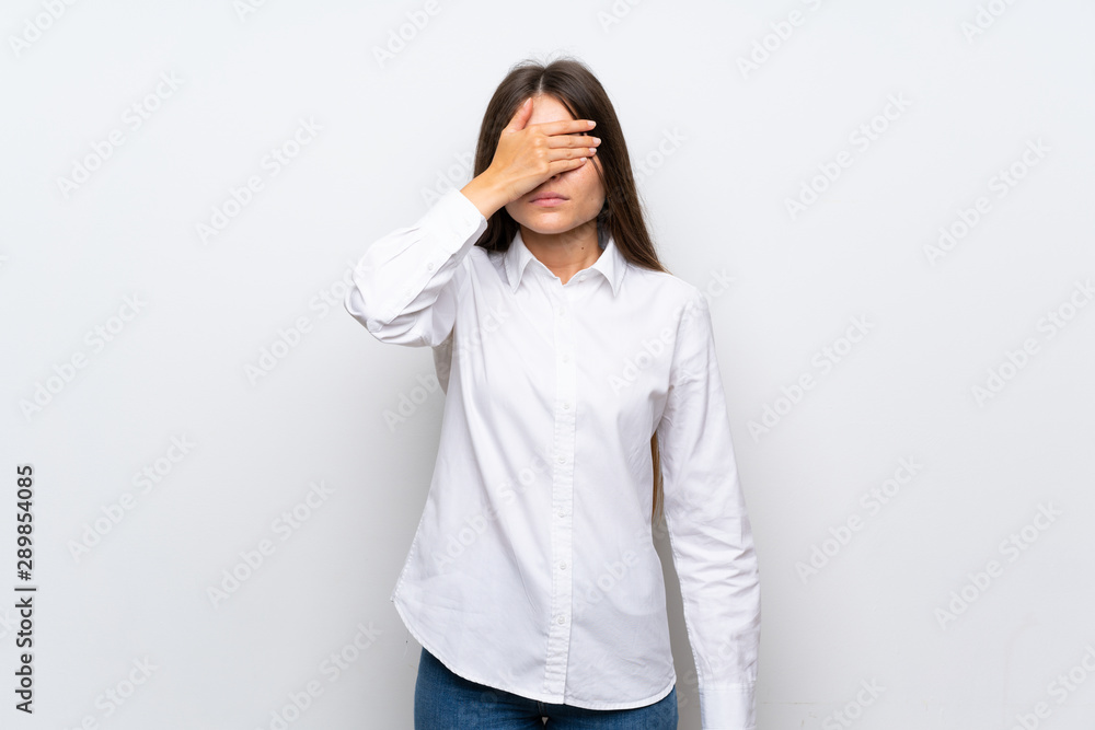 Young woman over isolated white background covering eyes by hands Young woman over isolated white background covering eyes by hands