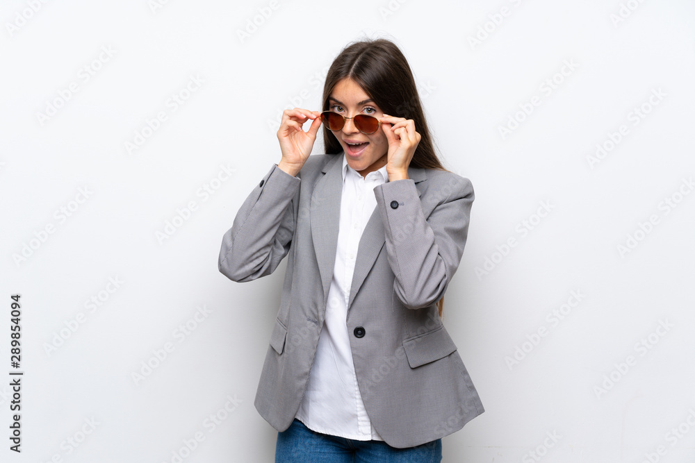 Young business woman over isolated white background with glasses and surprised Young business woman over isolated white background with glasses and surprised