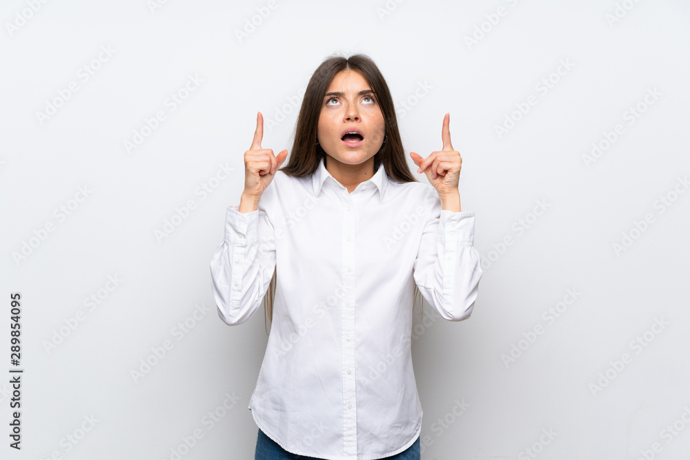 Young woman over isolated white background pointing with the index finger a great idea