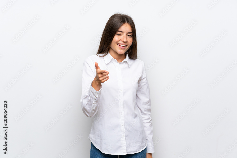 Young woman over isolated white background points finger at you Young woman over isolated white background points finger at you