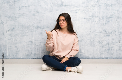 Teenager student girl studying in a table unhappy and pointing to the side Free Download Teenager student girl studying in a table unhappy and pointing to the side - GFXLoad