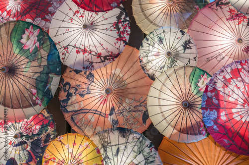 Many traditional Chinese oil paper umbrellas under the light