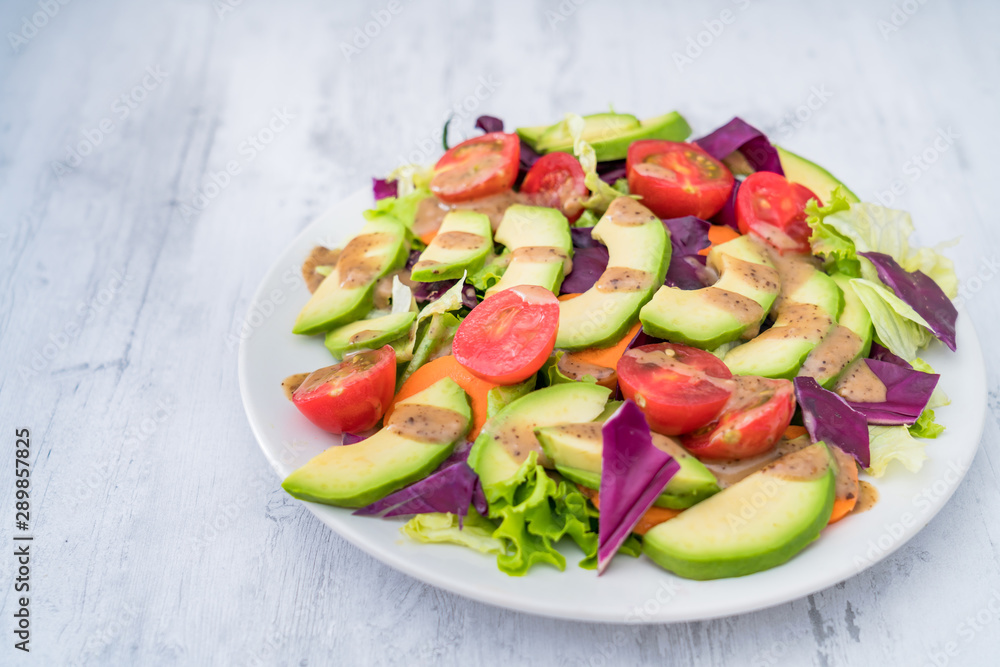 Healthy weight loss food: A plate of avocado and vegetable salad 