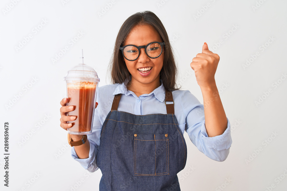 Chinese woman wearing glasses apron drinking smoothie over isolated white background annoyed and frustrated shouting with anger, crazy and yelling with raised hand, anger concept