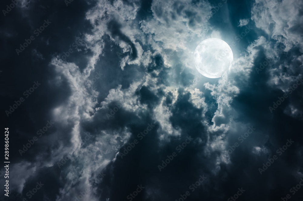 Landscape of sky with dark clouds at nighttime. Beautiful full moon behind cloudy with moonlight. Landscape of sky with dark clouds at nighttime. Beautiful full moon behind cloudy with moonlight.