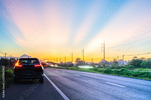 A beautiful sunset sky with cars on the road traveling