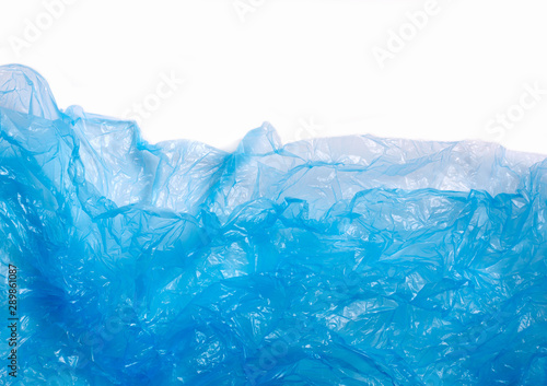 Blue plastic bag on white background. A White Plastic Bag Texture, macro, background. Reduction of plastic bags for natural treatment. The symbol of the campaign to refrain from using plastic bags.