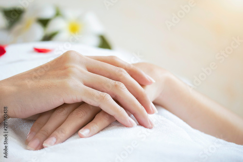 Close up woman hands showing beauty skin in spa salon.