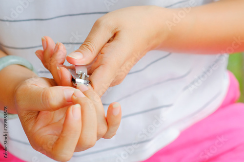 A woman cutting a nail