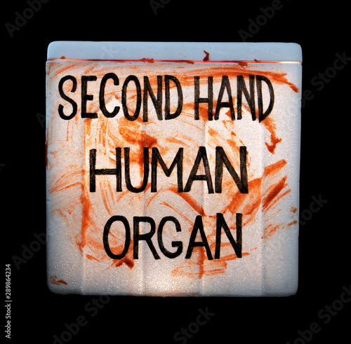 A cooling box with human organs for transplantation on black background. Illegal sale of human organs.