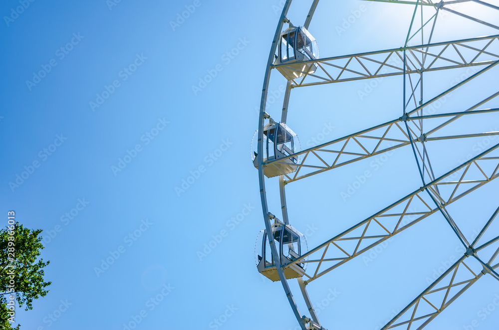 Ferris wheel whith pines on clear blue sky background. Ferris wheel whith pines on clear blue sky background.
