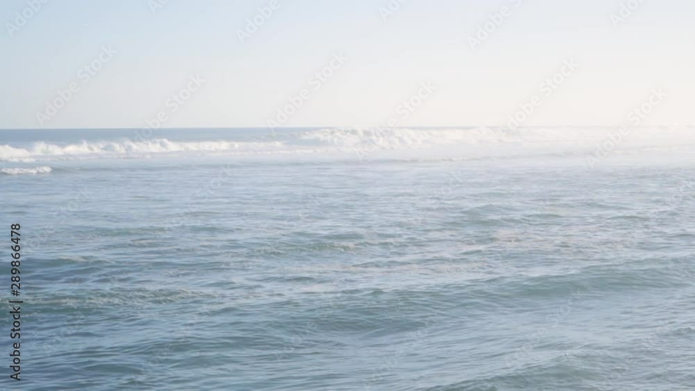 foamy waves roll up in the ocean at sunset foamy waves roll up in the ocean at sunset