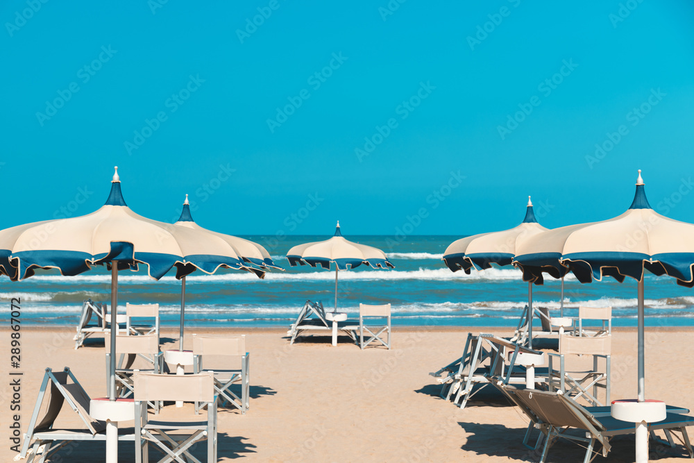 Beach in late summer, deck chairs and parasols
