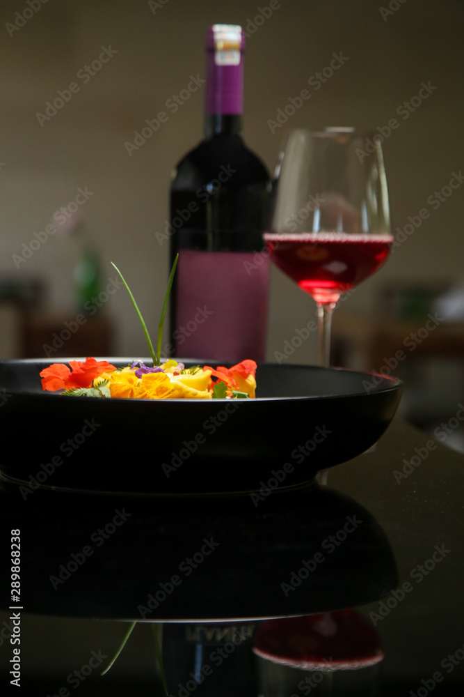 Vegetable curry decorated with edible flowers. Exquisite dish. Creative restaurant meal concept. Haute couture food on black. Fine dining concept. Vegetable curry decorated with edible flowers. Exquisite dish. Creative restaurant meal concept. Haute couture food on black. Fine dining concept.