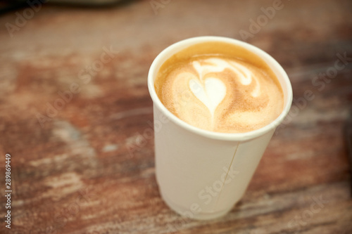Fototapeta Naklejka Na Ścianę i Meble -  Beautiful cappuccino with a heart in a paper cup