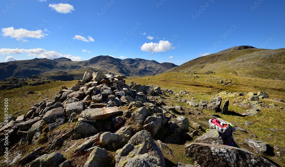 Walkers rucksack and the cairn on Base Brown Photos | Adobe Stock