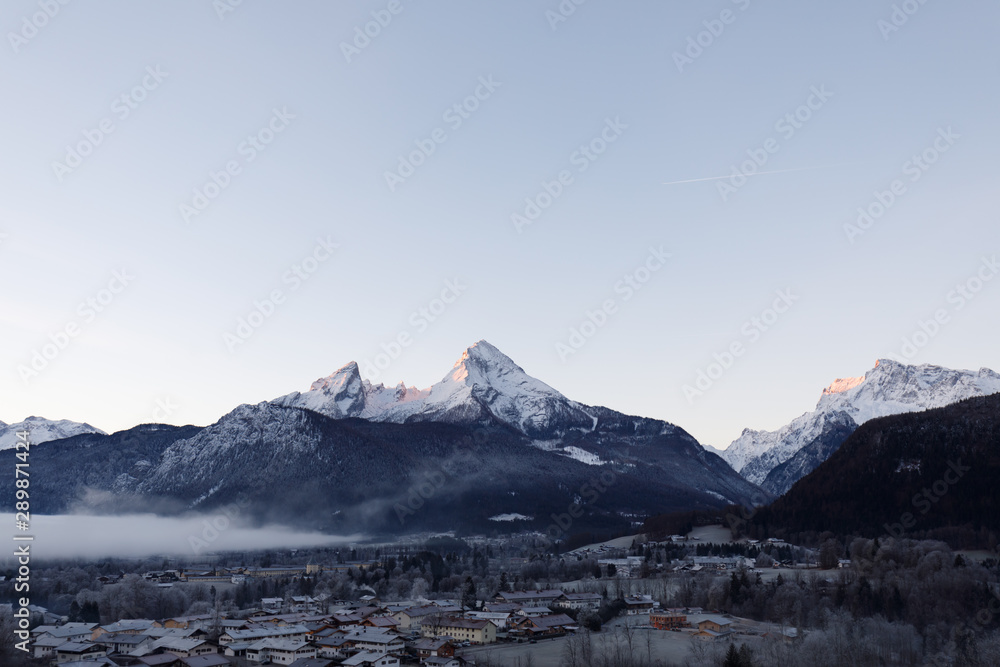 Berchtesgaden and Mountain Watzmann at sunrise in winter with fog in valley