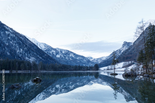 rocks in Lake Hintersee, Ramsau, Bavaria in winter at sunrise and reflexion