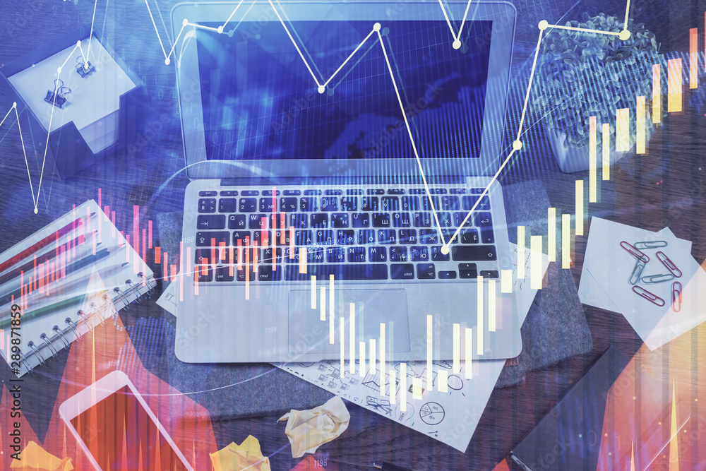 Double exposure of chart and financial info and work space with computer background. Concept of international online trading.