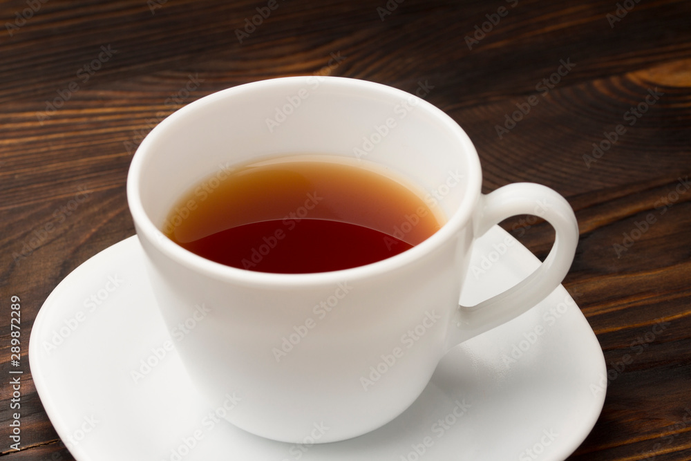 Cup of tea on wood table. close up 