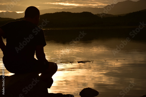 silhouette of man on the beach at sunset