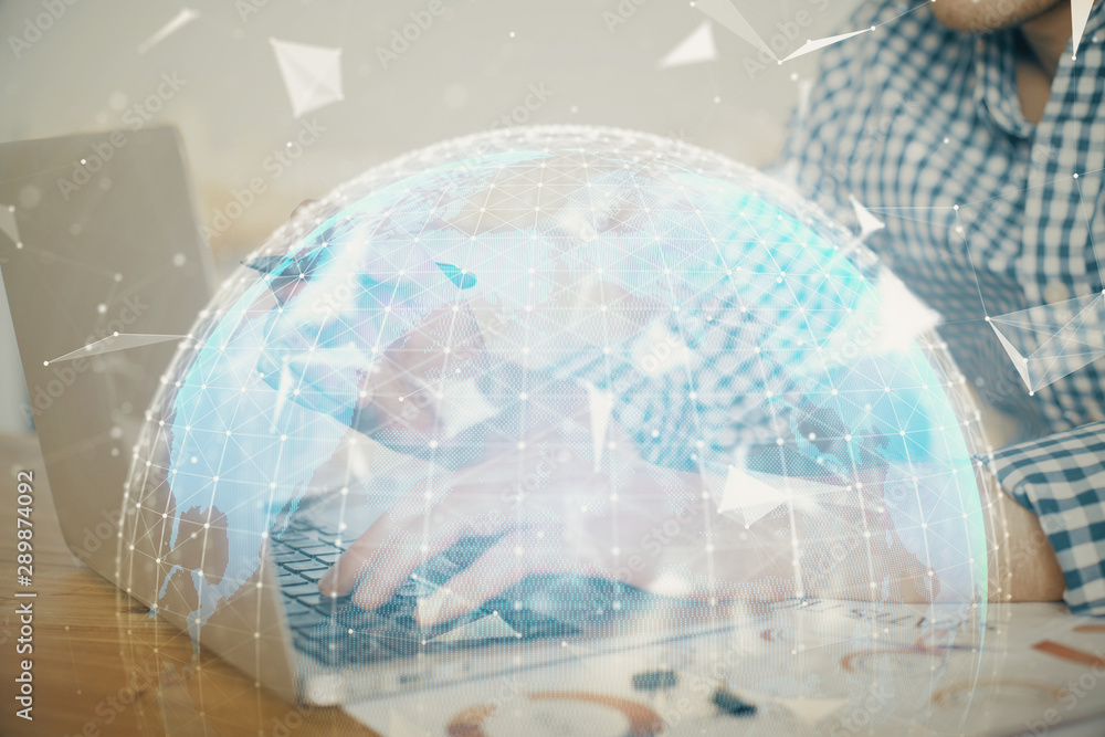 Multi exposure of businessman working on laptop on background. International business hologram in front. Concept of success. Multi exposure of businessman working on laptop on background. International business hologram in front. Concept of success.