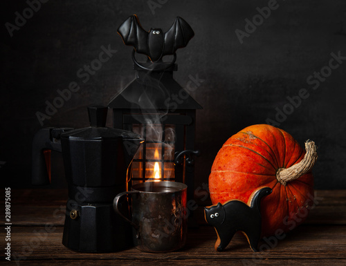 Black coffee pot, mug with black coffee, chocolate gingerbread, black lantern with  candle and apumpkin. Halloween concept, still life photo