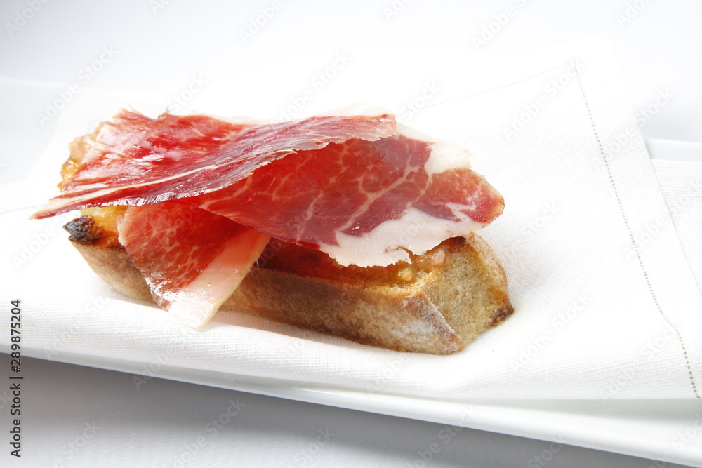 pincho aperitivo gourmet de jamón ibérico. Iberian ham gourmet appetizer skewer. pincho aperitivo gourmet de jamón ibérico. Iberian ham gourmet appetizer skewer.