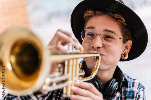 Photography close up of a stylish jazz man playing the trumpet very passionate