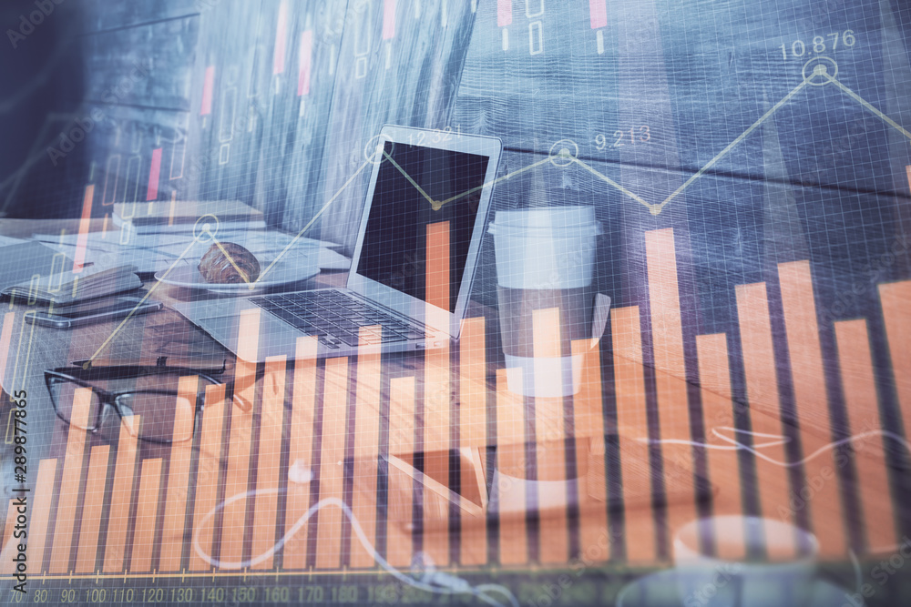 Financial chart drawing and table with computer on background. Multi exposure. Concept of international markets. Financial chart drawing and table with computer on background. Multi exposure. Concept of international markets.