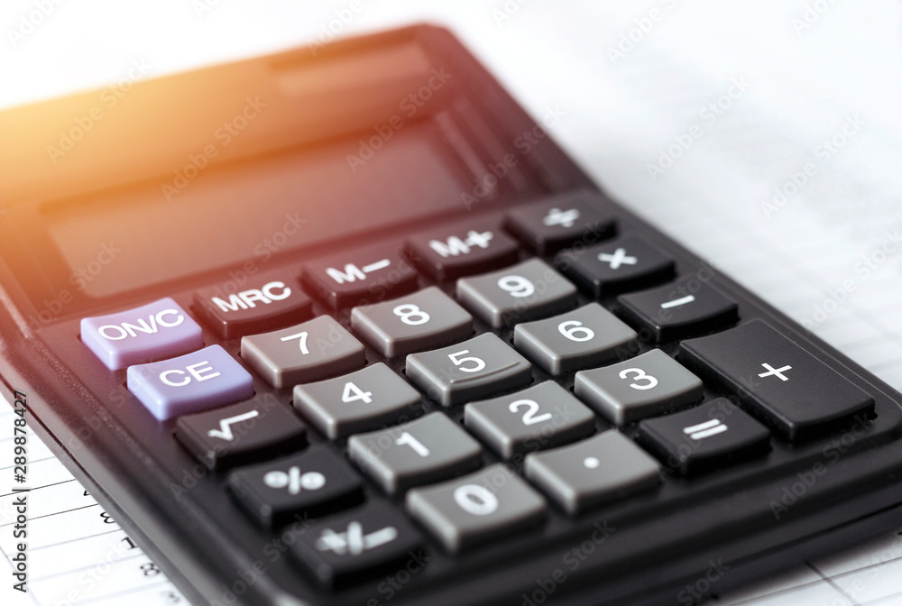Calculator on white paper with numbers. Business and Finance accounting concept. Calculator on white paper with numbers. Business and Finance accounting concept.